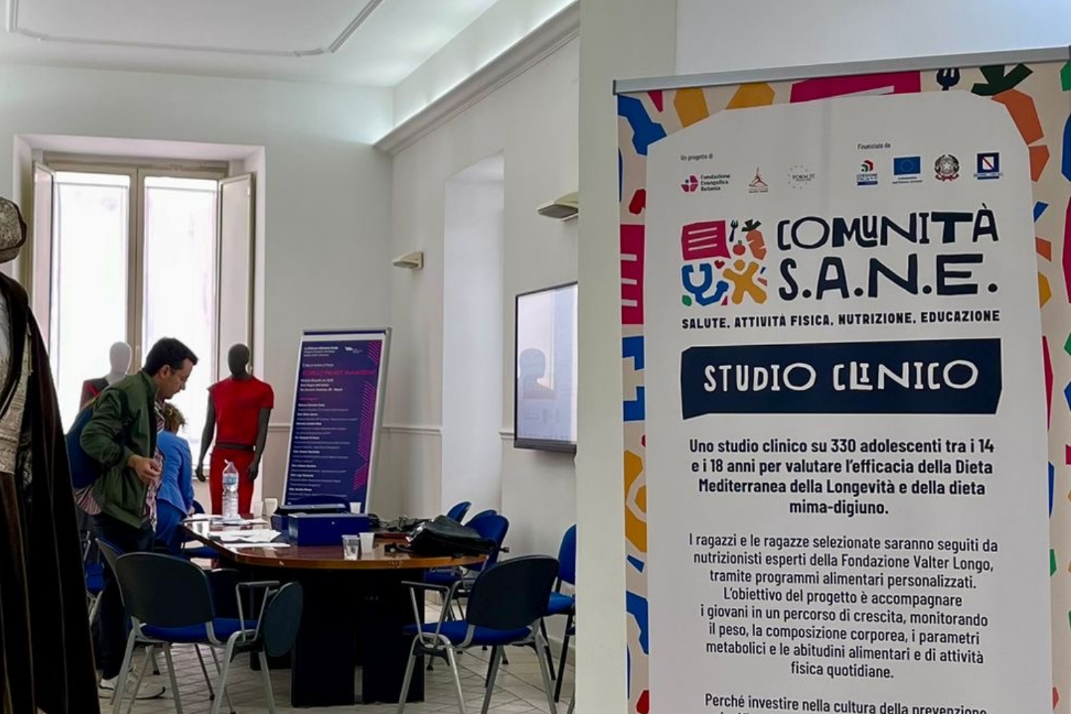 Banner del progetto Comunità S.A.N.E. con le informazioni sullo studio clinico, Napoli, maggio 2026